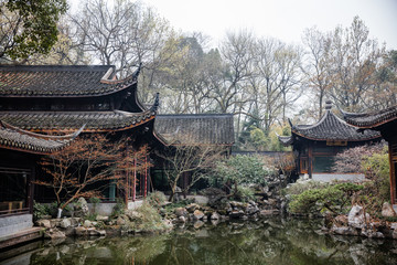 traditional chinese architecture and tea house reflecting on a pond with red carps (translation: tea house)