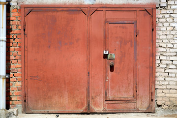 Red garage doors with three locks.
