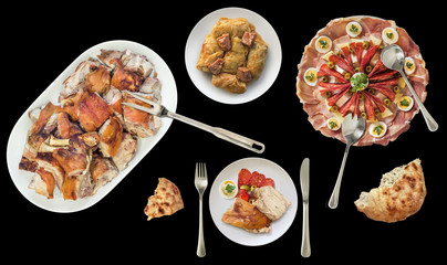 Roasted Pork meat slices with garnished savory Appetizer dish and Pickled Cabbage Rolls with leavened Flatbread torn loaf isolated on black background