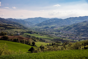 View of Tuscany valley with farms and hills
