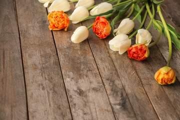 Beautiful tulips on wooden background