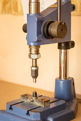 Pressing machine in clothes and accessories manufacture. Clench installing device at workshop