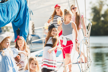 Obraz premium The children on board of sea yacht