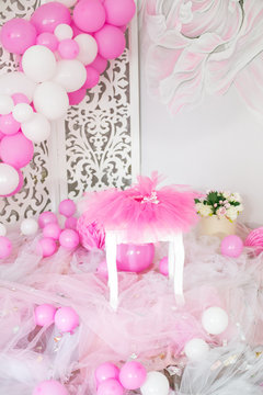 First birthday. Pink skirt-tutu, crown, and balloons and flowers decorated party