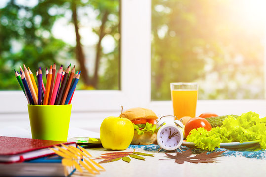 School Accessories And An Appetizing Lunch On The Table, Free Space.