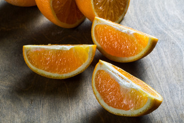 sliced three orange slices on a rustic table closeup