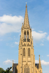 Fototapeta na wymiar Poland, Katowice - 12/06/2018: catholic cathedral against blue sky. Church facade. Religious journey. Europe travel. Polish landmark. 