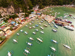 Fototapeta na wymiar Aerial view of the beach with fishing boats. Elnido, Philippines, 2018.
