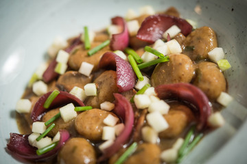 Close up of vegan dish with potatoe and onion