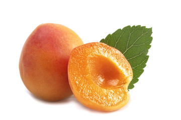 one whole ripe colorful apricot with a cut half