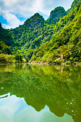Fototapeta premium Crystal clear warer of lake Trang An Scenic Landscape in Ninh Binh, Vietnam