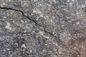 Crack in granite stone. Texture