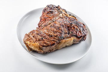 White round plate with Whole grilled T-bone steak