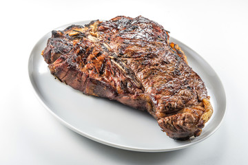 White round plate with Whole grilled T-bone steak