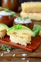 Sandwiches with cheese and avocado slices on pieces of rice gluten free bread