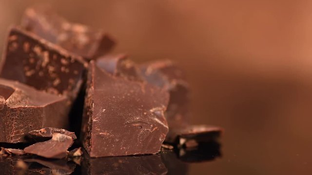 Chocolate. Chunks of sweet dark chocolate rotated closeup. Dessert ingredient. Confectionery. Slow motion 4K UHD video 3840X2160
