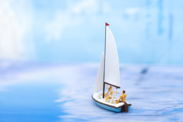 Naklejka premium Miniature people, Rowing boat in the ocean. Image use for sports concept.