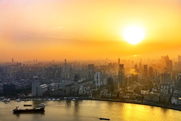 Fototapeta premium Shanghai cityscape sunset twilight with smog lies over the skyline of Historical architecture and modern skyscraper on the bund of Shanghai, China