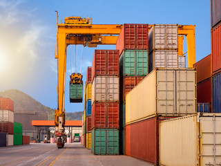 The RTG(Rubber Tried Gantry Cranes) is moving full loaded containers at industrial port and...