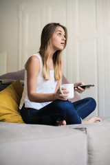 Young woman watching tv