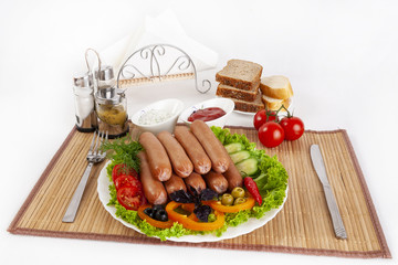 Boiled sausages with tomatoes, cucumbers and greens. Served with black or white bread.