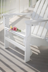 Fototapeta na wymiar Adirondack chair on a sunny porch