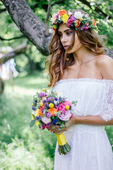 Obraz premium Bride with the wedding bouquet and flower wreast.