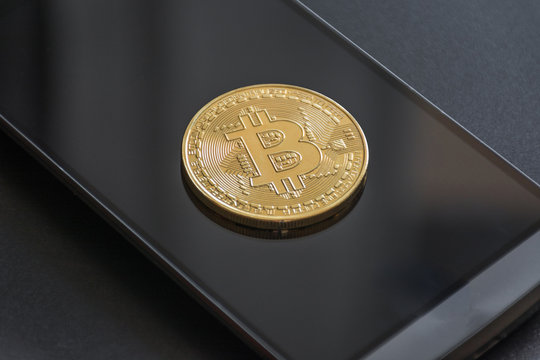 cryptocurrency called bitcoin with laptop and a smartphone.