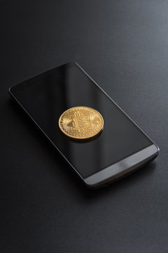 cryptocurrency called bitcoin with laptop and a smartphone.