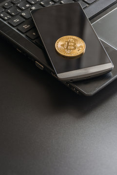 cryptocurrency called bitcoin with laptop and a smartphone.