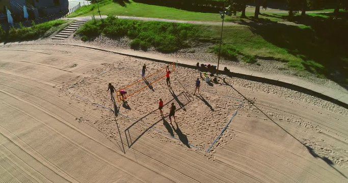 Beach Volley, C4k aerial view around people playing volleyball on Hietaranta beach, on a sunny summer morning dawn, in Hietaniemi, Helsinki, Uusimaa, Finland
