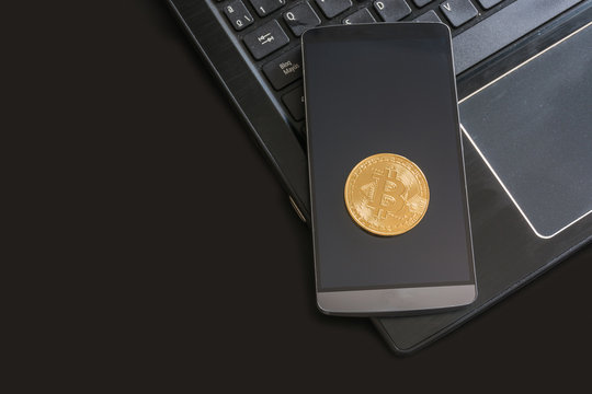 cryptocurrency called bitcoin with laptop and a smartphone.