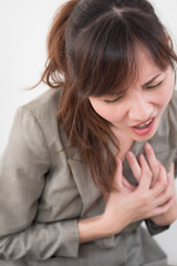 Fototapeta premium woman with sudden heart attack; sick woman suffering from acute heart attack, concept of emergency health care; asian young adult woman model