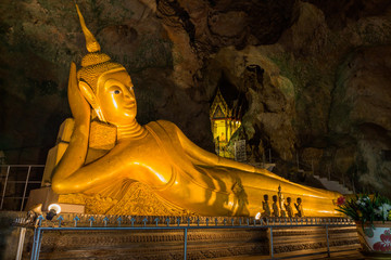 The golden reclining Buddha of Thumb Suwanna Kuha temple in Phang Nga province. the temple is inside the cave.