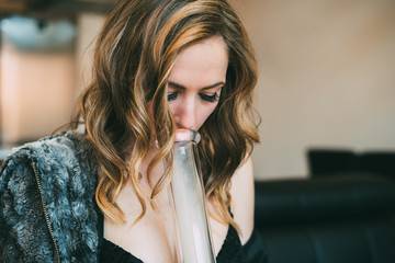 Woman smoking marijuana in a bong