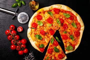 Pizza Margarita with Mozzarella and Basil on the Black Background Bake Snack with Tomatoes