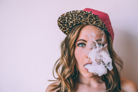 Skater woman smoking a cannabis joint
