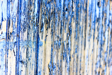 Ancient wooden background with paint. The paint from the sun almost peeled off. Shallow depth of cut