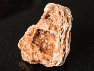 Wulfenite crystals on raw rock on black
