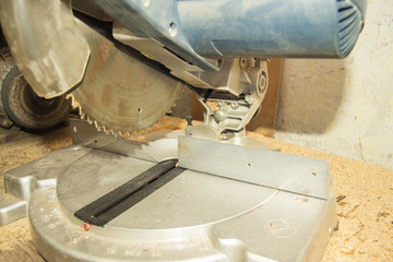 Electric saw on wood in the workshop, for cutting woodwork, close-up