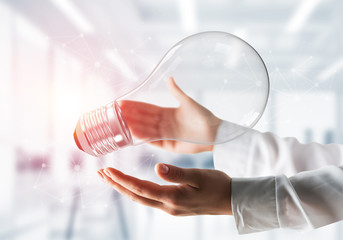 Good idea concept by means of lightbulb in hands.