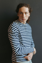 Obraz premium Portraits of a guy with an attractive appearance, curly hair and stylish clothes