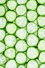 Fresh green slices of cucumber as background