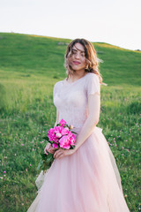 Happy bride in a pink dress