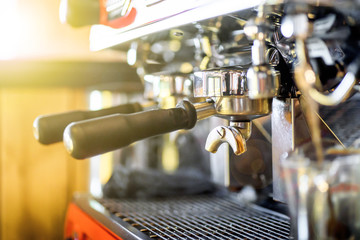 Close up professional coffee machine making espresso in a cafe