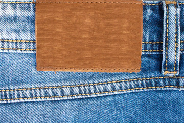 Blank leather jeans label sewed on a blue jeans