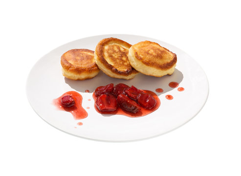Fritters with strawberry jam on a dish.