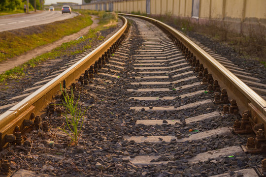 Rail tracks in the green field. - Powered by Adobe