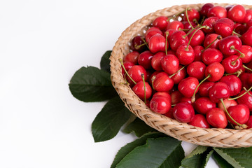 Tasty cherries in a basket isolated on a white background
