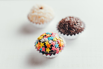 Handmade brazilian sweets: Beijinho and Brigadeiro. Common in children birthday party. Macro, close up